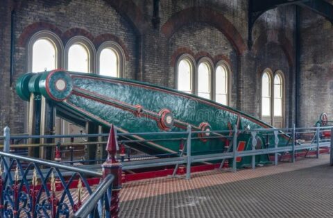 Large Victorian green industrial engine inside a brick pumping station